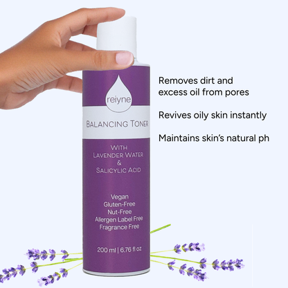 Reiyne Balancing Toner with Lavender and Salicylic Acid in a white bottle with purple and white label