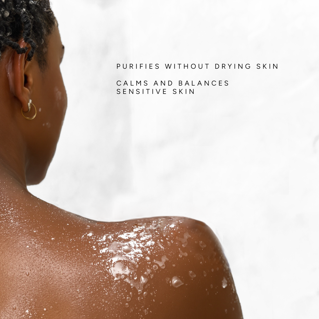 Reiyne Bare Body Wash for Sensitive Skin in a white pump bottle and a green and white label