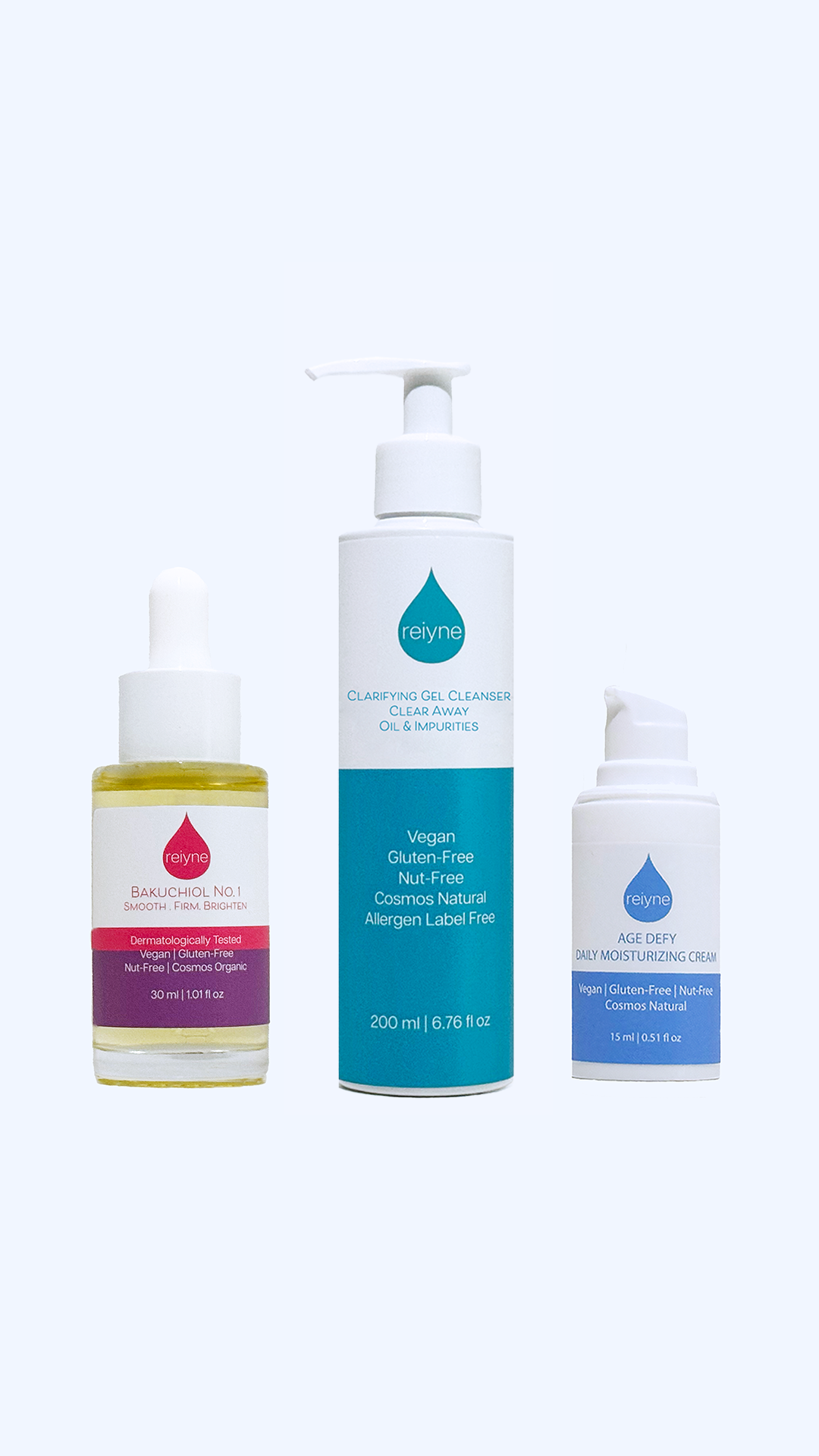 Reiyne Breakouts Be Gone Set with Reiyne Acne Gel Cleanser and Reiyne Age Defy Daily Moisturizer and Reiyne Bakuchiol No. 1 in a white and purple box in a grey background