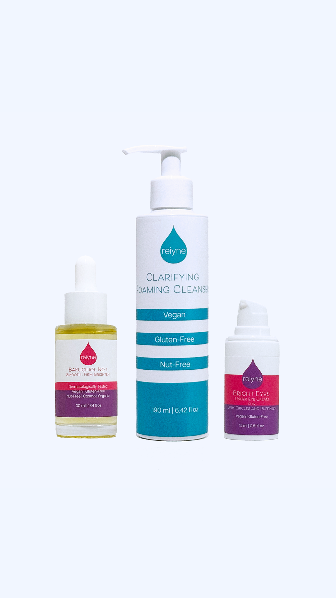 Reiyne Radiant Revival Trio Contains Bakuchiol Oil in Pink, purple and white dropper bottle with clarifying foaming cleanser in blue and white pump bottle and Bright Eyes under eye cream with pink and purple airless pump bottle